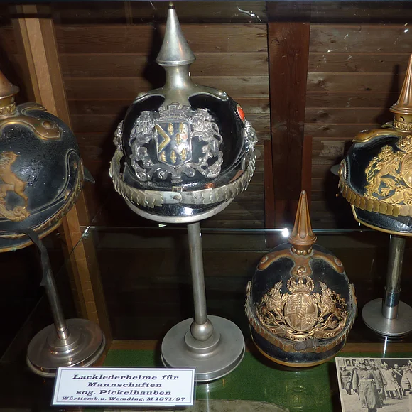 Militärische Kopfbedeckungen im Heimatmuseum in Wemding Fünf verschiedene Pickelhauben in einer Vitrine