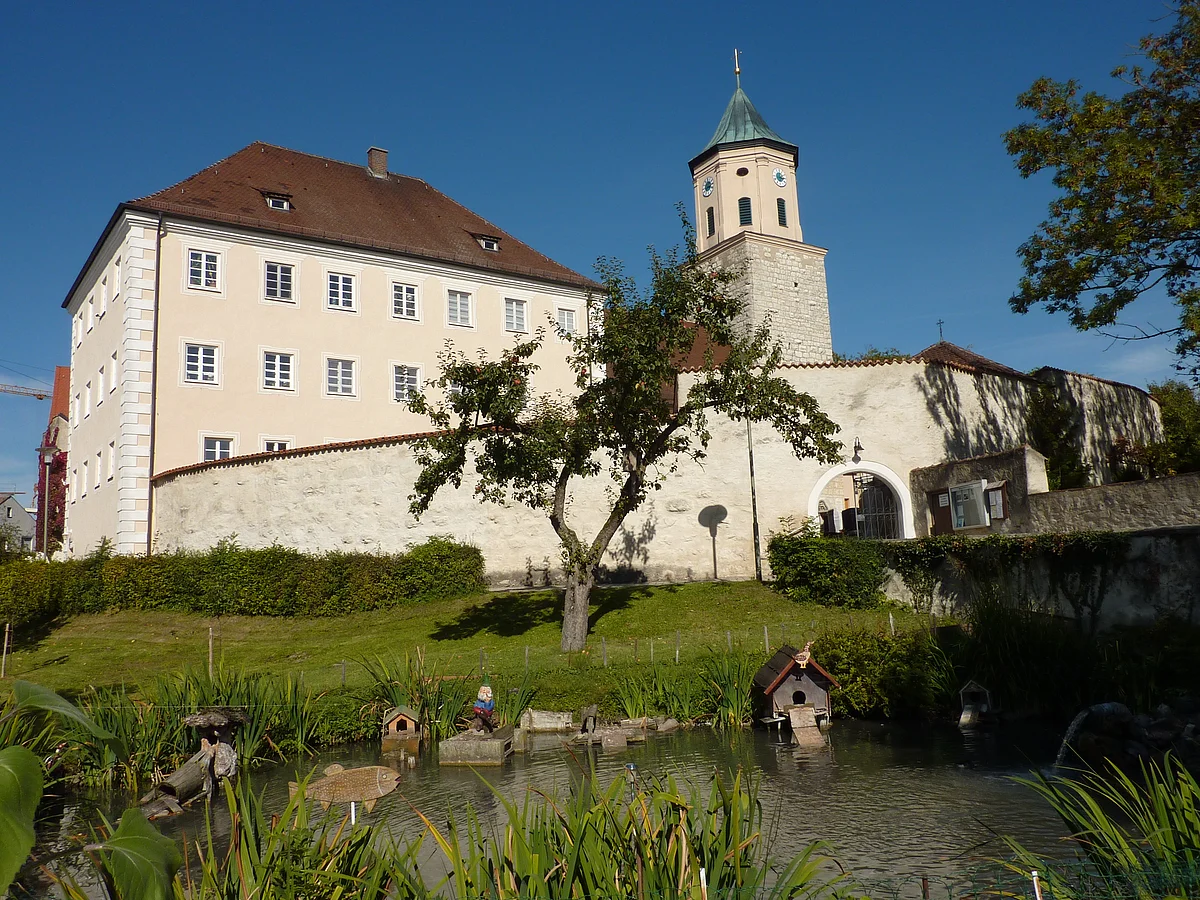 Ehemalige Schloss Gosheim mit Weiher und Pfarrkirche Mariä Geburt Blick auf das ehemalige Schloss Gosheim mit davor liegendem Weiher. Rechts neben dem Schloss sieht man den Turm der Pfarrkirche Mariä Geburt.