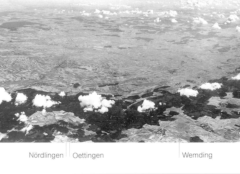 Panoramica del Ries da circa 3.000 m d’altezza (dettaglio) Die schwarz-weiße Luftaufnahme zeigt den Rieskrater mit dem bewaldeten Kraterrand und Wolken darüber. Linien zeigen die Lage der Städte Nördlingen, Oettingen und Wemding.